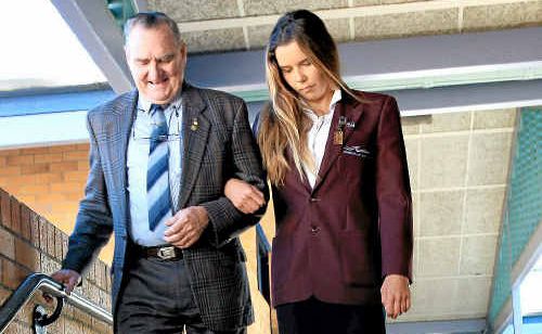 Kingscliff High School captain Codie Klein escorts VC winner Keith Payne on his visit to the school.